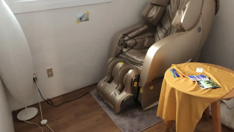 A full-body massage chair in a bright room